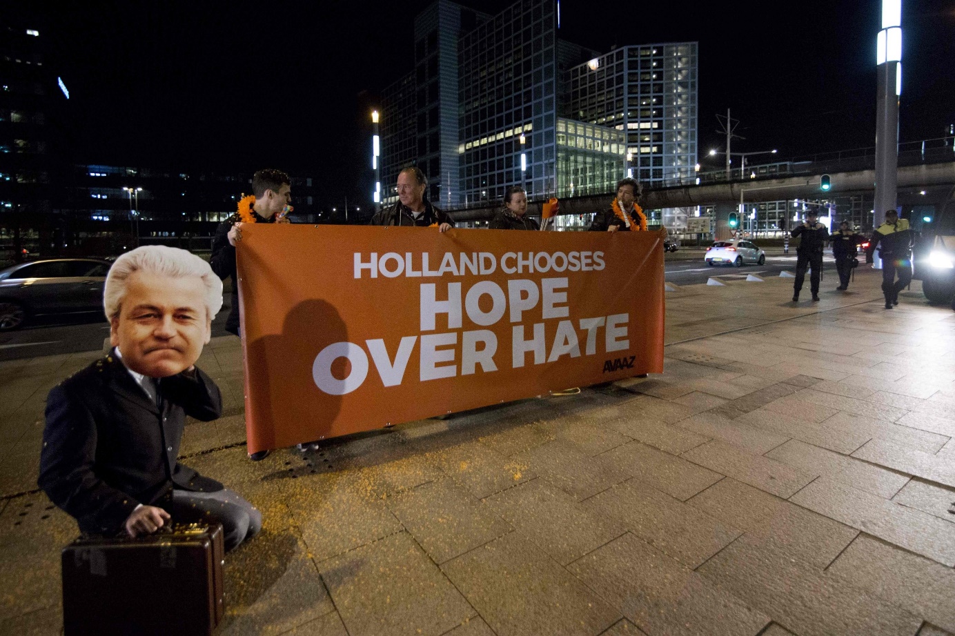 Members of a civic organization celebrate the victory of center-right VVD party in the general elections, in The Hague on March 15, 2017. (AFP Photo)