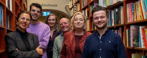 Afbeelding met Menselijk gezicht, persoon, glimlach, boekenkast Door AI gegenereerde inhoud is mogelijk onjuist.